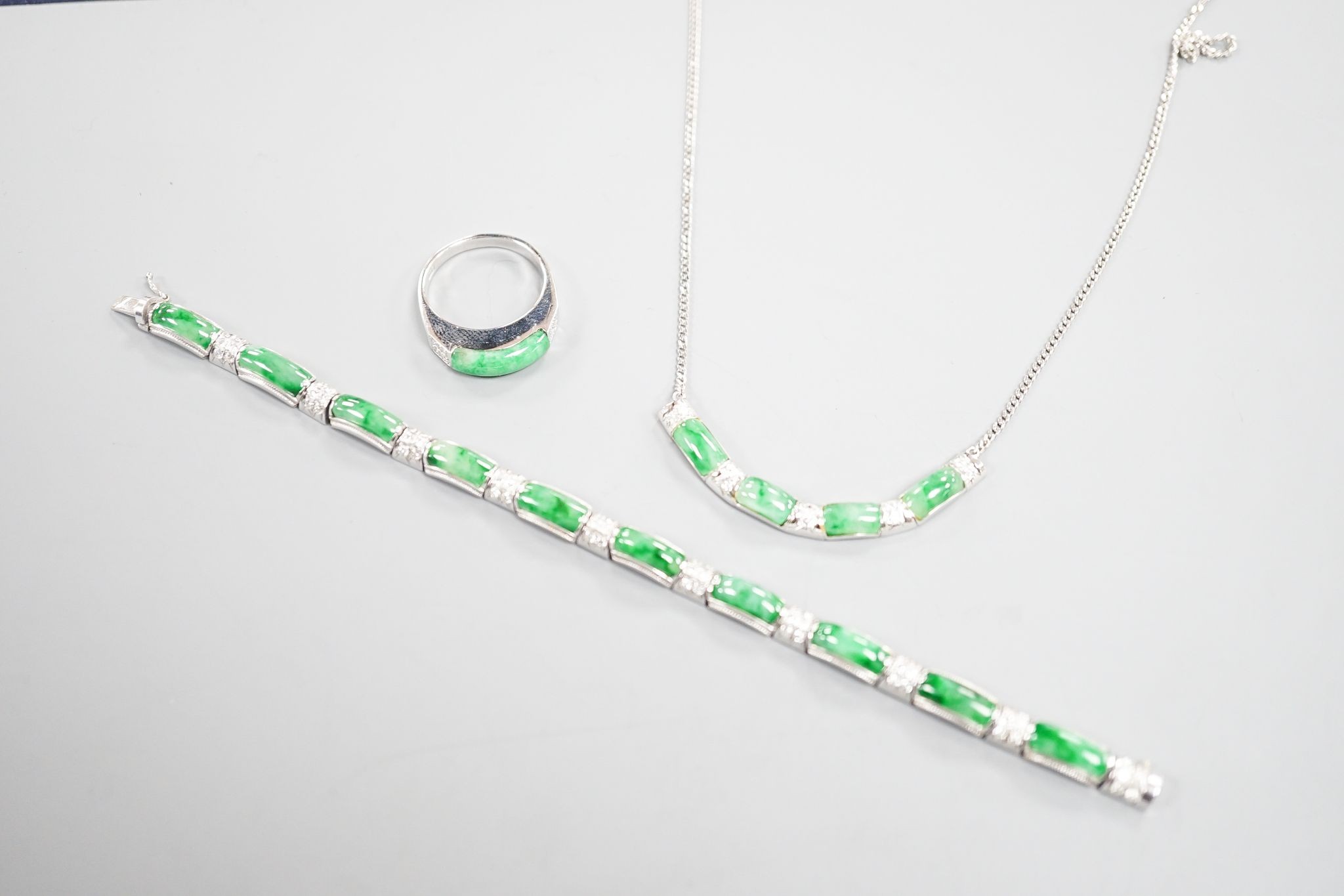 A modern white metal (stamped 850), jade and diamond cluster set bracelet, approx. 15.5cm, with a matching ring, size O and necklace, 38cm